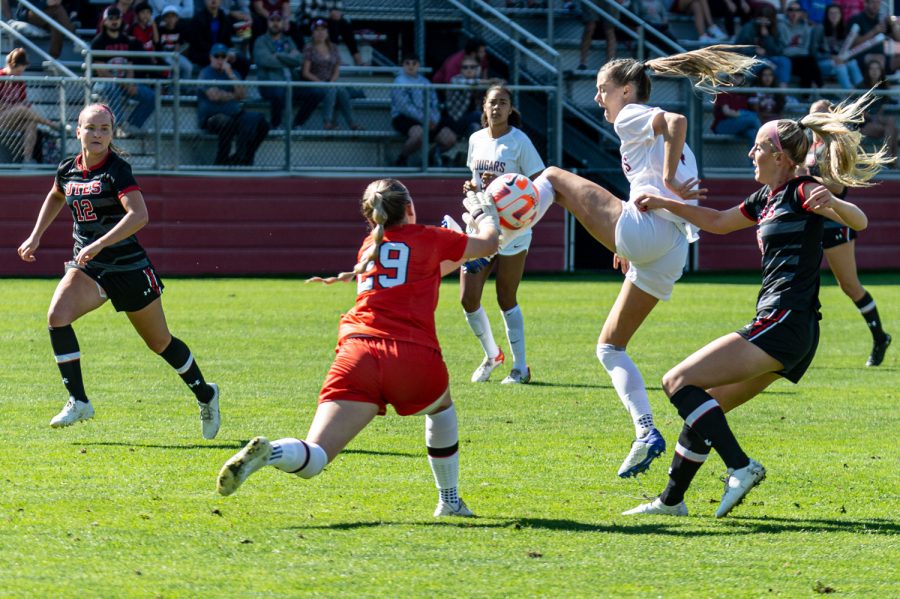 WSU forward Grayson Lynch beats Utah goalkeeper Evie Vitali to the ball during an NCAA womens soccer match, Oct. 2. Lynch scored to put the Cougs up 1-0.