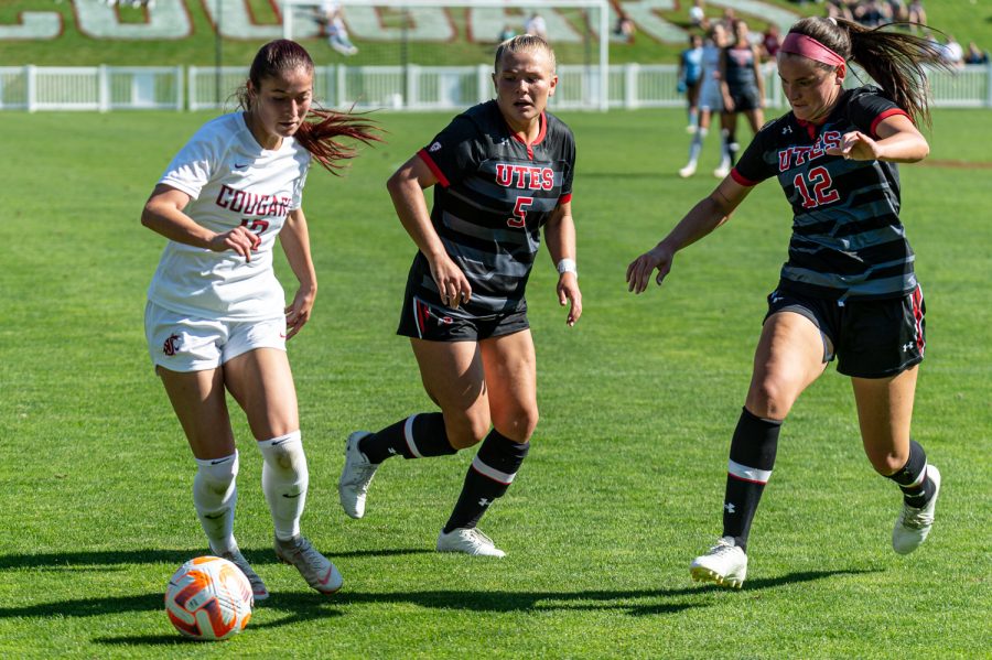 WSU forward Lily Boyden dribbles around Utah midfielder Luisa Delgado (5) and defender Jade Gosar (12) during an NCAA womens soccer match, Oct. 2.
