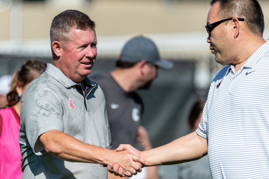 WSU womens soccer head coach Todd Shulenberger shakes hands with athletic director Patrick Chun after securing his 89th career victory against Utah, Oct. 2.