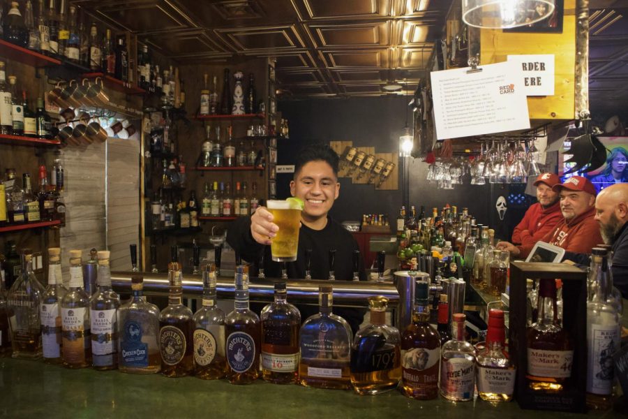 Alfonso Ortega works behind the bar at Red Card Pub