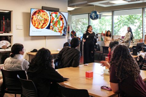 Rehael Mufti, senior double majoring in marketing and human resources, gives a presentation on different foods from around the world, Sep. 30.