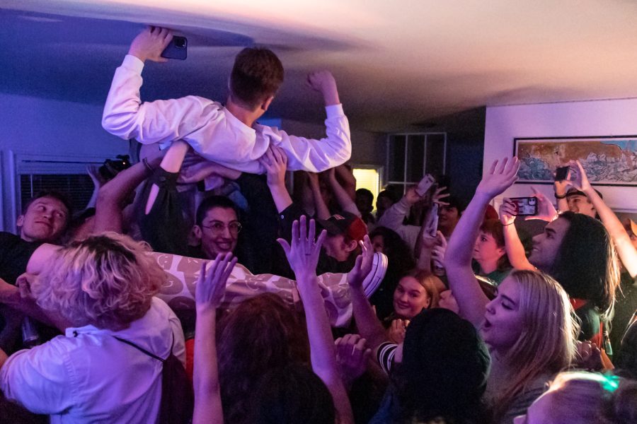 Crowd members hold up WSU senior Jack Christensen into the air during a performance by Snacks at Midnight, Sept. 9.