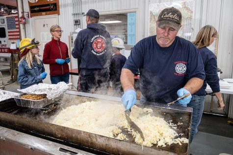 Volunteer firefighter Blake Blauert cooks hashbrowns during Lincoln County Fire District Fours annual Hunters Breakfast fundraiser, Oct. 15, in Reardan, Wash.