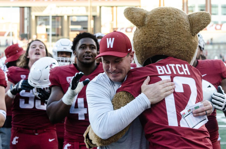 WSU head coach Jake Dickert celebrates with Butch T. Cougar after defeating California 28-9, Oct. 1.