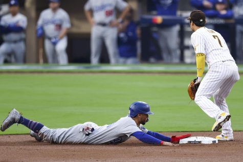 Los Angeles Dodgers right fielder Mookie Betts, left, takes second base on a wild pitch ahead of the tag by San Diego Padres shortstop Ha-Seong Kim during the first inning in game 3 of the NLDS at Petco Park on Friday, Oct. 14, 2022, in San Diego
