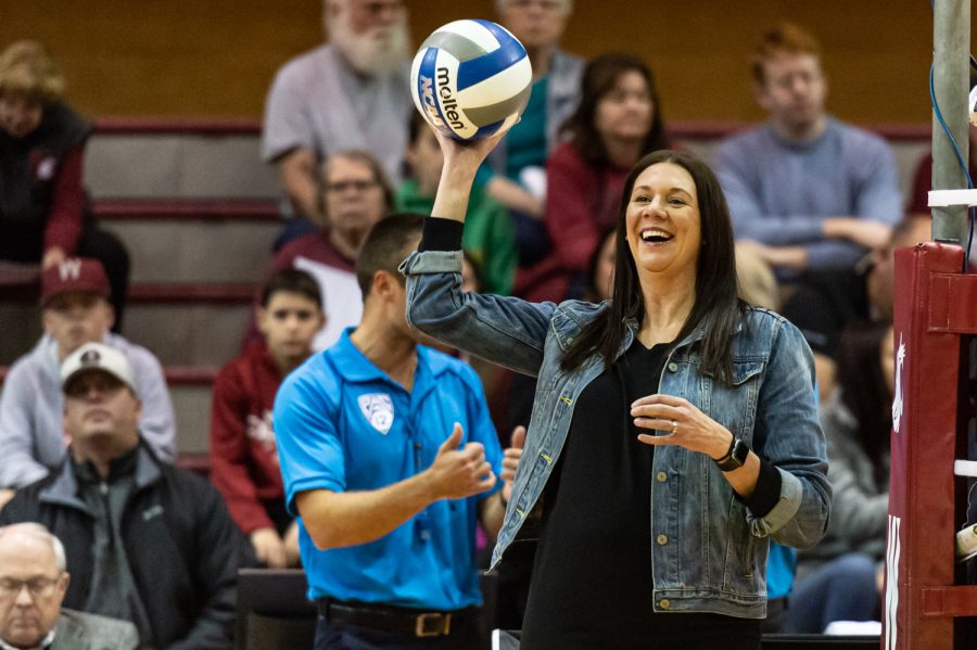 WSU volleyball head coach Jen Greeny catches a ball during warm-ups before an NCAA volleyball match against Utah, Nov. 18, 2022.
