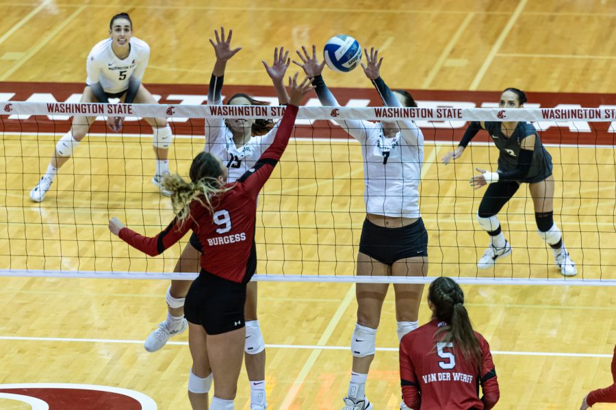 WSU middle blocker Magda Jehlarova (15) and outside hitter Pia Timmer (7) attempt to block a spike from Utah middle blocker KJ Burgess during an NCAA volleyball match, Nov. 18.