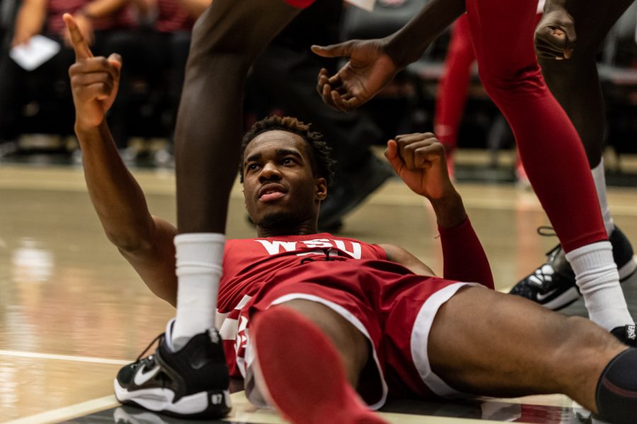 WSU guard Kymany Houinsou lies down after scoring and getting fouled during an NCAA mens basketball game against Detroit Mercy, Nov. 25.