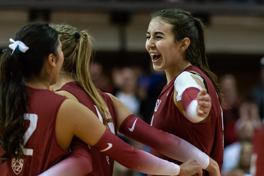 WSU opposite Katy Ryan celebrates with her teammates after scoring a point during an NCAA volleyball match against UW, Nov. 25.
