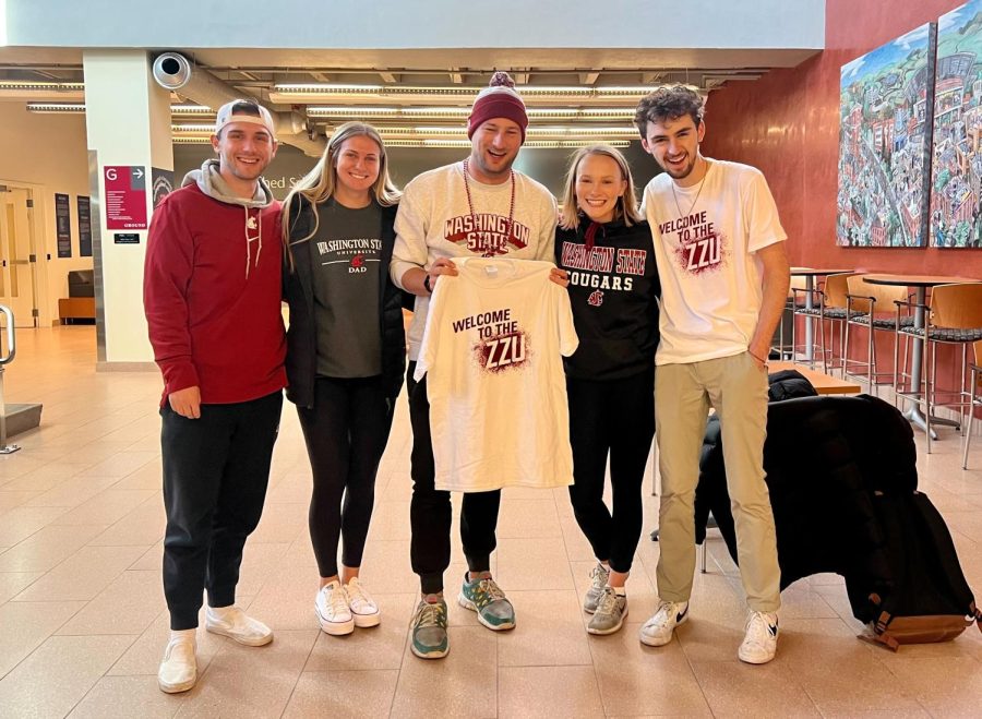 Leaders+of+ZZU+CRU%2C+WSUs+offical+student+section%2C+present+Ben+Chase+%28center%29+a+ZZU+CRU+shirt+prior+to+the+WSU+vs.+Utah+football+game+on+Oct.+27.