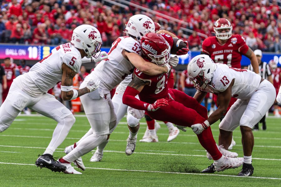 WSU linebacker Kyle Thornton tackles Fresno State (52) tight end Raymond Pauwels Jr. (87) during the 2022 Jimmy Kimmel LA Bowl, Dec. 17, in Los Angeles.