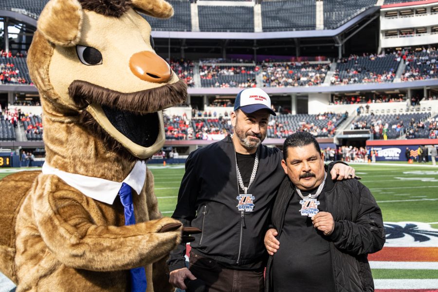 Jimmy Kimmel, Guillermo Rodriguez, and bowl mascot Jimmy Kamel pose for a photo at midfield before the 2022 Jimmy Kimmel LA Bowl, Dec. 17, in Los Angeles.