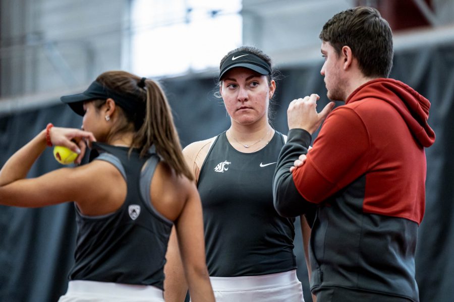 WSU tennis assistant coach Fons Verberne talks with players Stefaniia Mikhailova and Fifa Kumhom during an NCAA match against Montana, Jan, 13.