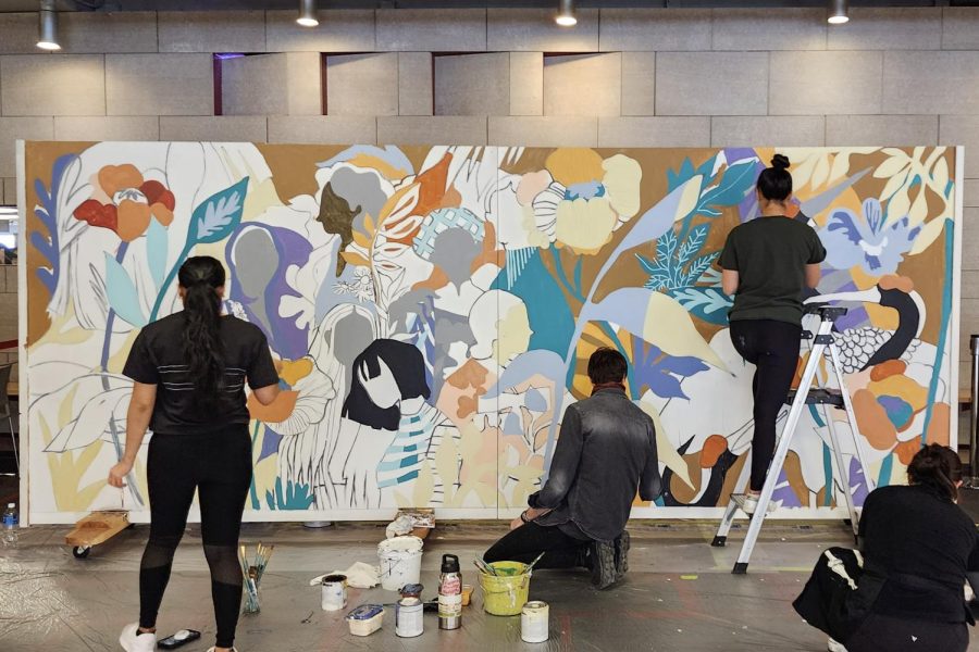 Jiemei Lin and her team paint the Racial Healing Wall on a canvas in the CUB Jan. 17, 2023.