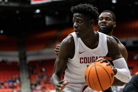 WSU forward Mouhamed Gueye dribbles toward the basket during an NCAA basketball game against Oregon State, Feb. 16, 2023, in Pullman, Wash.