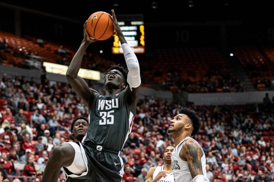 WSU forward Mouhamed Gueye jumps for a dunk during an NCAA basketball game against UW, Feb. 11, 2023, in Pullman, Wash.
