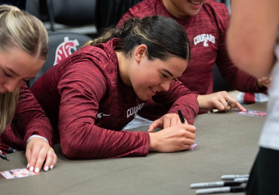 WSU guard Charlisse Leger-Walker signs a trading card during a post game autograph session after an NCAA basketball game against Cal, Sunday, Feb. 5, 2023, in Pullman, Wash.