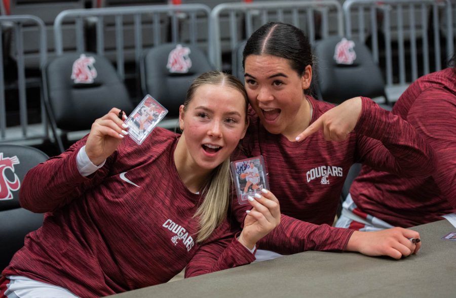 WSU guard Johanna Teder and WSU guard Charlisse Leger-Walker pose with trading cards of themselves during a post game autograph session after an NCAA basketball game against Cal, Sunday, Feb. 5, 2023, in Pullman, Wash.