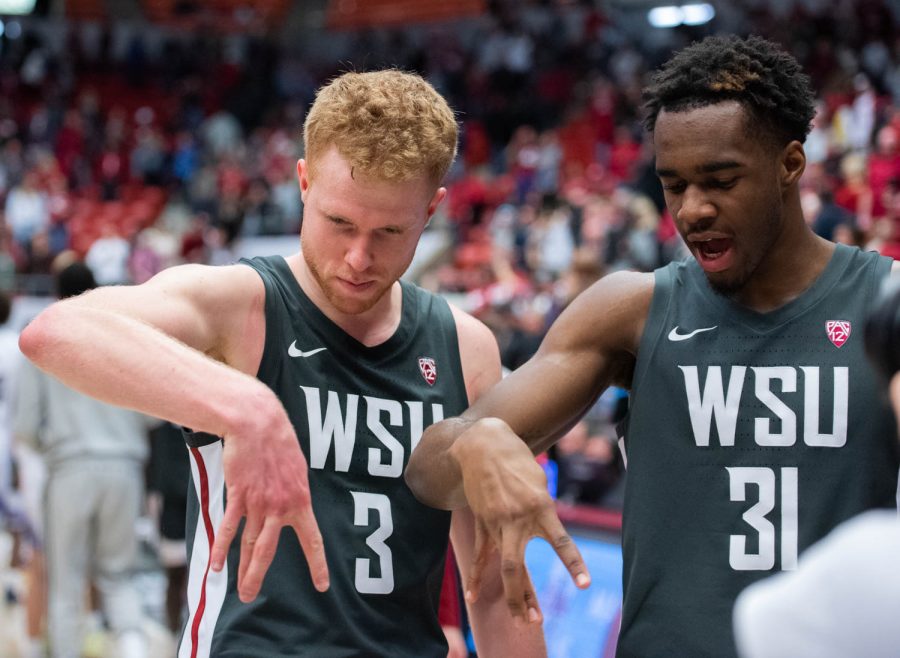 WSU guard Jabe Mullins and WSU guard Kymany Houinsou celebrate after winning the NCAA basketball game against UW, Feb. 11, 2023, in Pullman, Wash.