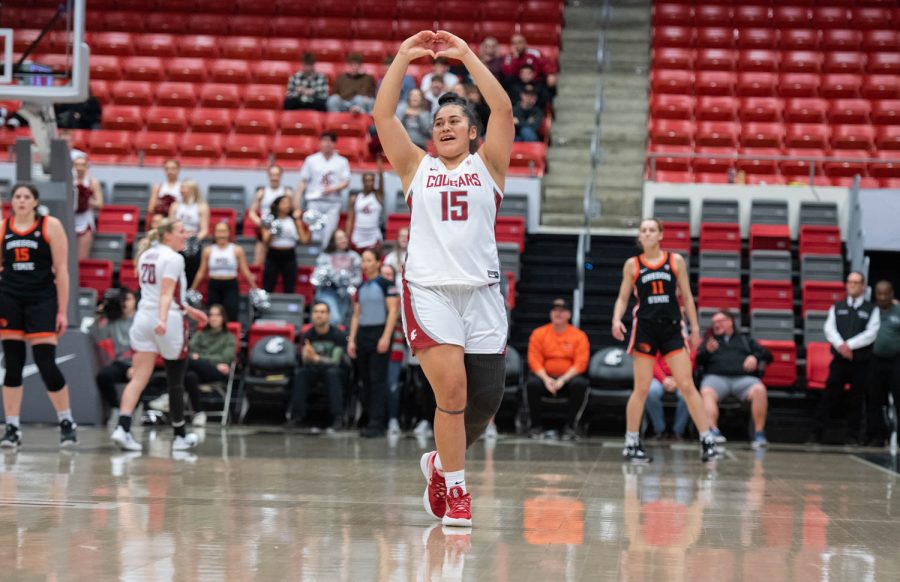 WSU forward Ula Motuga makes a heart with her hands while leaving the court during her last game in Beasley Coliseum, Sunday, Feb. 19, 2023, in Pullman, Wash.