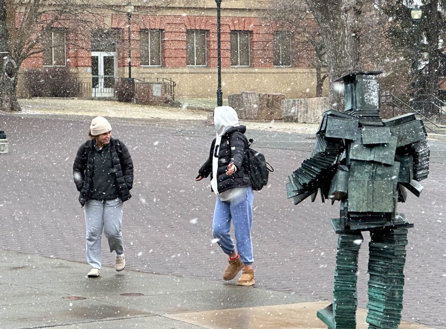 Two students dancing and having fun in the snow on Feb. 21 on Terrell Mall.