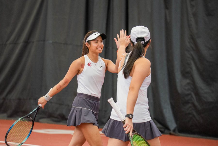 WSU tennis player Fifa Kumhom celebrates with her partner Yang Lee during an NCAA tennis match against UCLA, Sunday, March 5, 2023, in Pullman, Wash. 