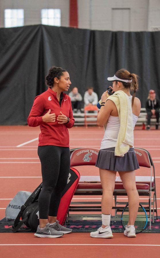 WSU tennis head coach Raquel Atawo talks with WSU tennis player Yura Nakagawa during an NCAA tennis match against UCLA, Sunday, March 5, 2023, in Pullman, Wash.