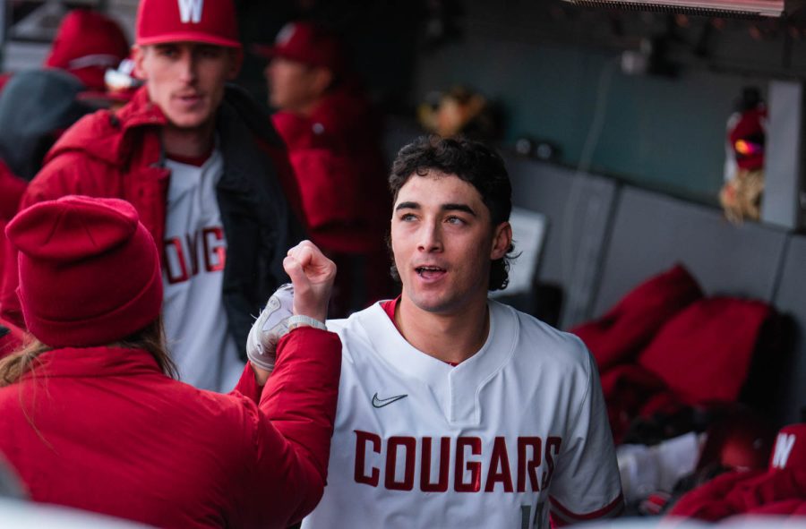 WSU catcher Jacob Morrow celebrates in the dugout after hitting a home run during an NCAA baseball game against Southern Indiana, Saturday, March 4, 2023, in Pullman, Wash.