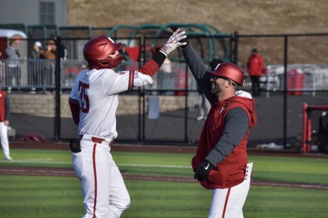 WSU first baseman Sam Brown celebrates with Brian Green after hitting a home-run with during an NCAA game against Seattle University, Tuesday, March 7, 2023, in Pullman, Wash.