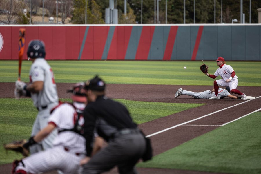 WSU first baseman Sam Brown catches a throw from pitcher Grant Taylor during an NCAA baseball game against Arizona, April 16, 2023, in Pullman, Wash.