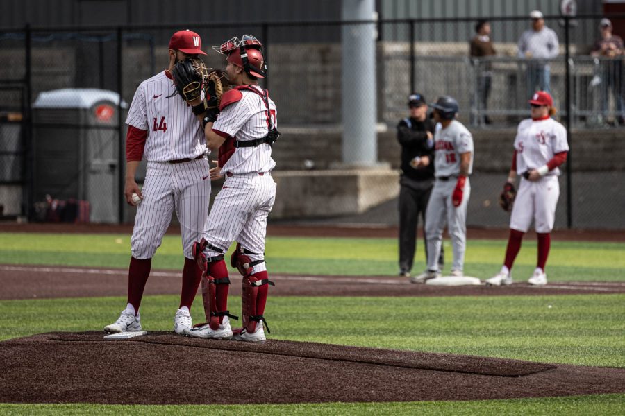 WSU pitcher Grant Taylor speaks with catcher Will Cresswell at the mound during an NCAA baseball game against Arizona, April 16, 2023, in Pullman, Wash.