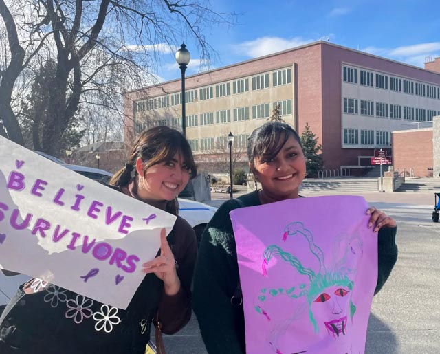 Students hold up posters during a rally to support survivors of sexual assault and abuse, April 14, 2023. 