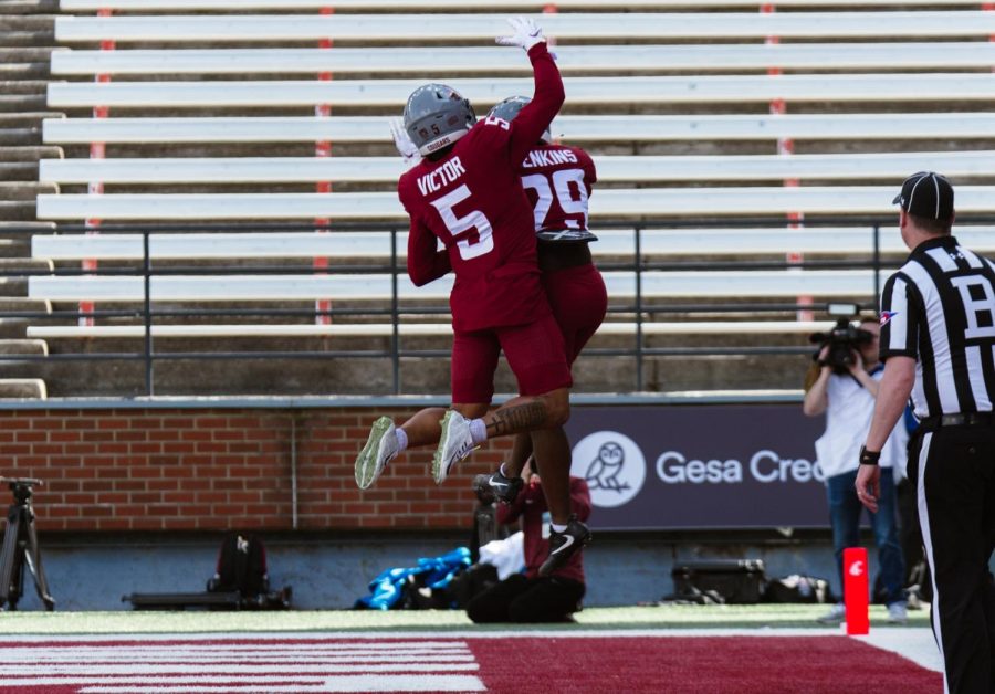 WSU football players Lincoln Victor and Jaylen Jenkins celebrate a touchdown during the WSU football spring game, Saturday, April 22, 2023, in Pullman, Wash.