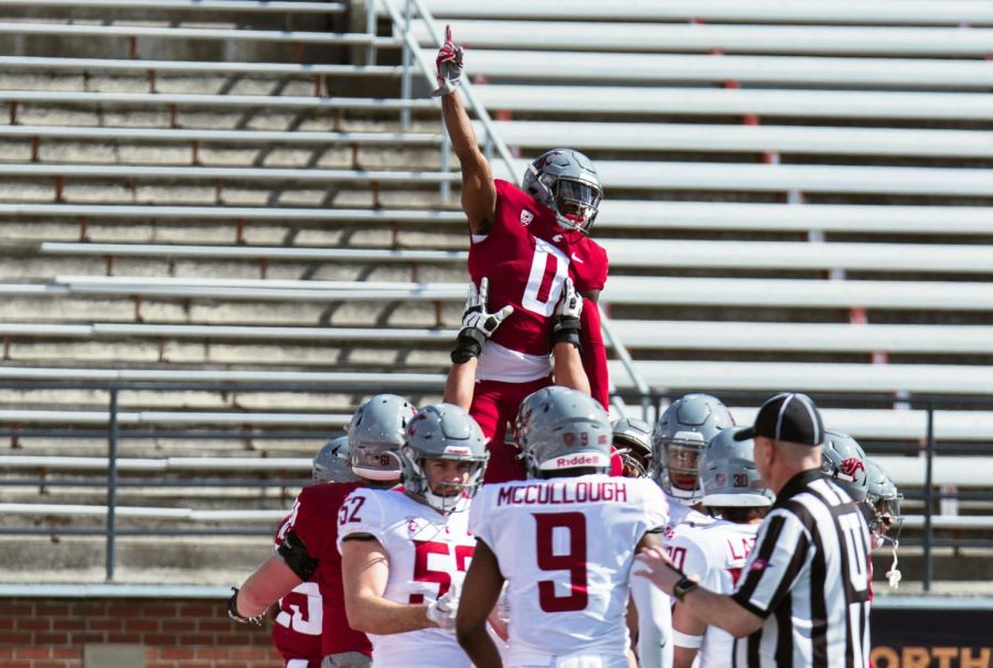WSU wide receiver DT Sheffield celebrates with his team after scoring a touchdown during the WSU football spring game, Saturday, April 22, 2023, in Pullman, Wash.