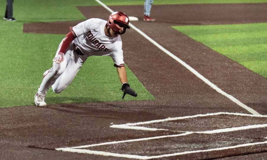 WSU infielder Cam Magee dives for home base during an NCAA baseball game against Gonzaga, Tuesday, May 2, 2023 in Pullman, Wash. 