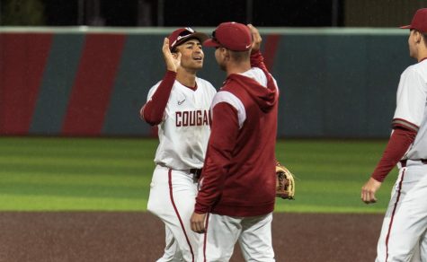 WSU Infielder Cam Magee high fives one of his coaches after an NCAA baseball game against Gonzaga, Tuesday, May 2, 2023 in Pullman, Wash. 