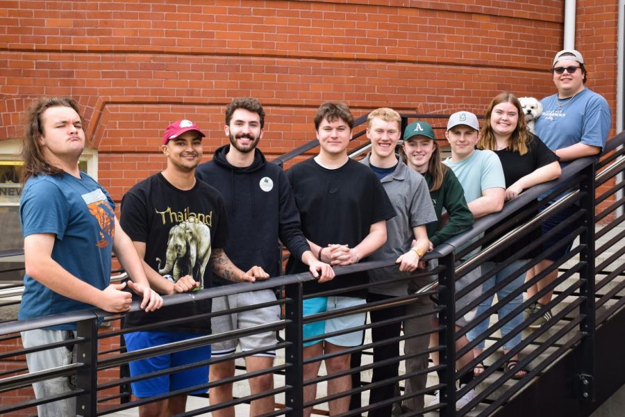 Approximately half of the spring 2023 Evergreen sports section poses for a group photo in front of Murrow Hall, May 4, 2023.