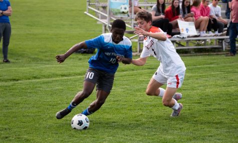 Clarens Dollin dribbles past a defender in PHS second playoff game, May 10.