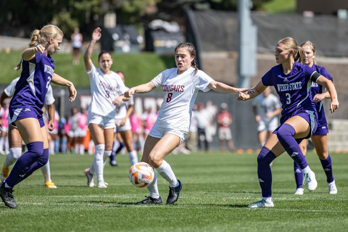 WSU midfielder Megan Santa Cruz dribbles through Weber State’s defense during an NCAA soccer game, Aug. 27, 2023, in Pullman, Wash.