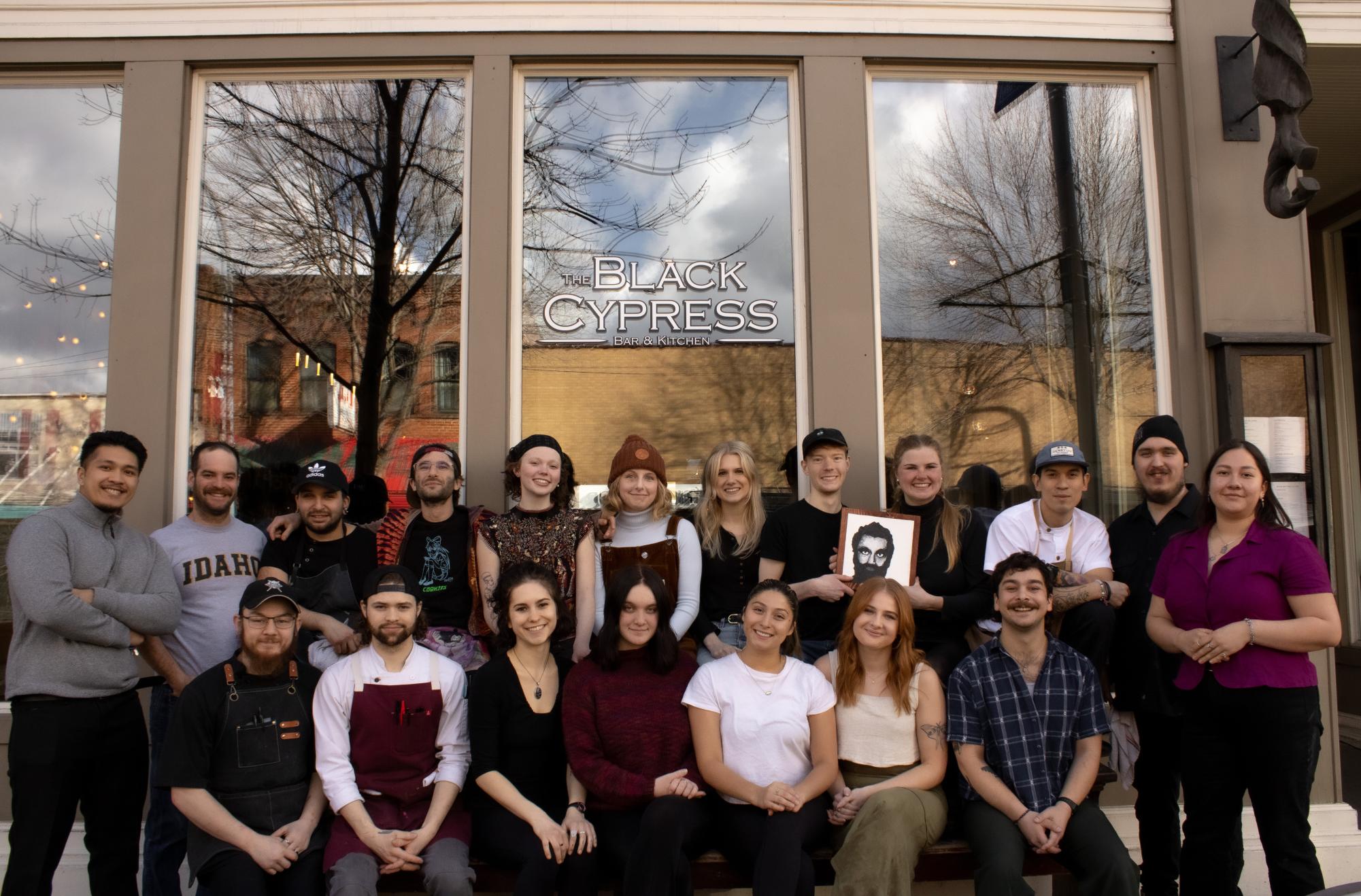 Staff of the Black Cypress pose for a group portrait outside of their award-winning restaurant.
