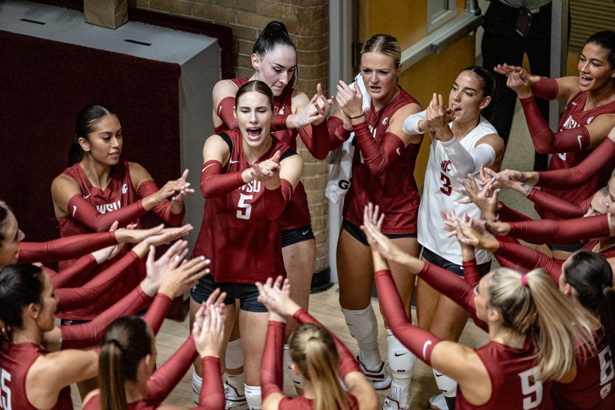 The WSU volleyball team makes their entrance onto the court before an NCAA volleyball match against UW, Sept. 21, 2023, in Pullman, Wash.