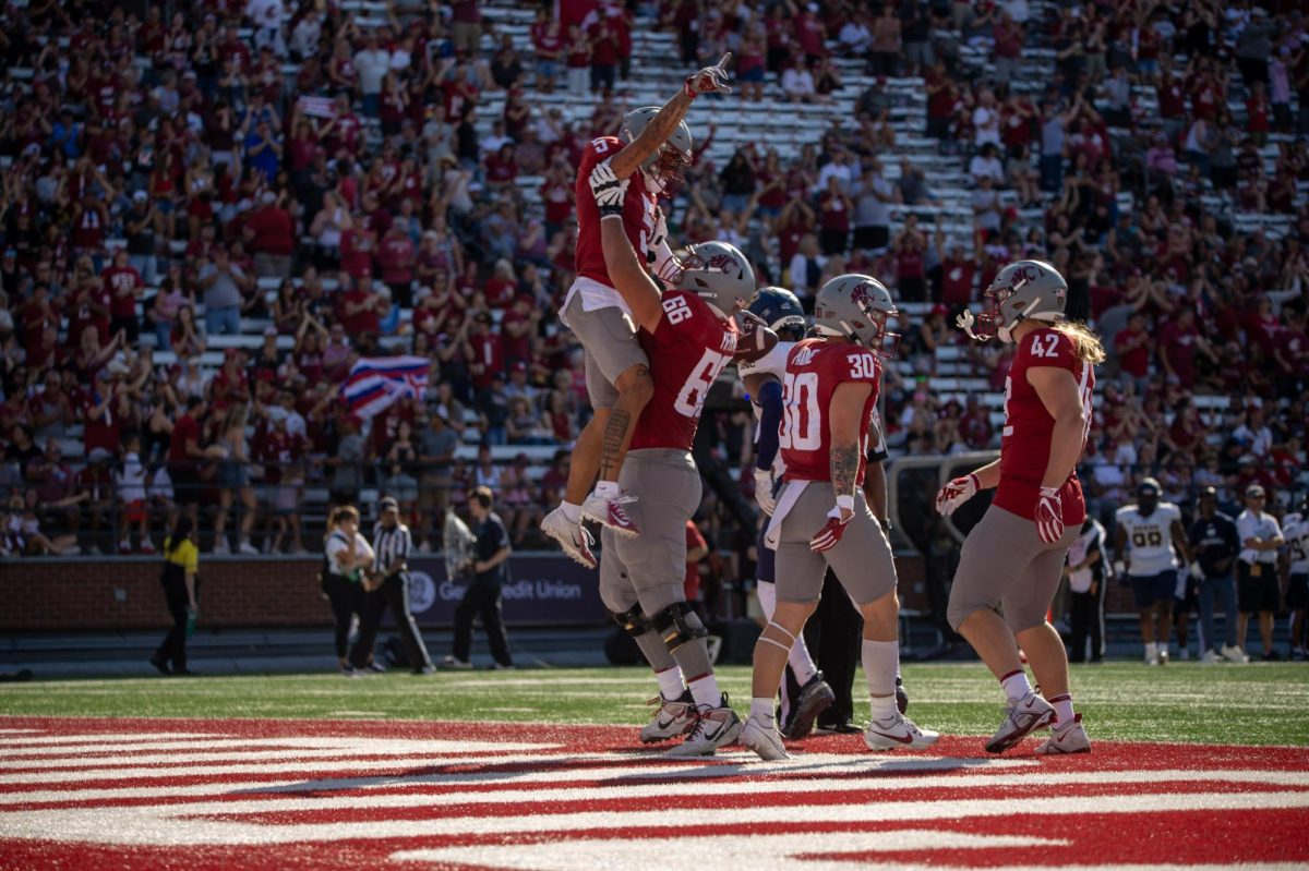WSU receiver Lincoln Victor celebrates scoring a touchdown with lineman Maake Fifita in an NCAA football game against Northern Colorado Sept. 16, 2023 at Martin Stadium in Pullman, Wash.