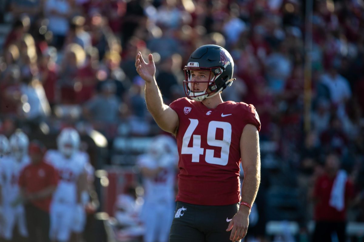 Dean+Janikowski+lines+up+an+extra+point+attempt+to+maintain+Cougs+lead+against+Wisconsin%2C+Sept.+9.+
