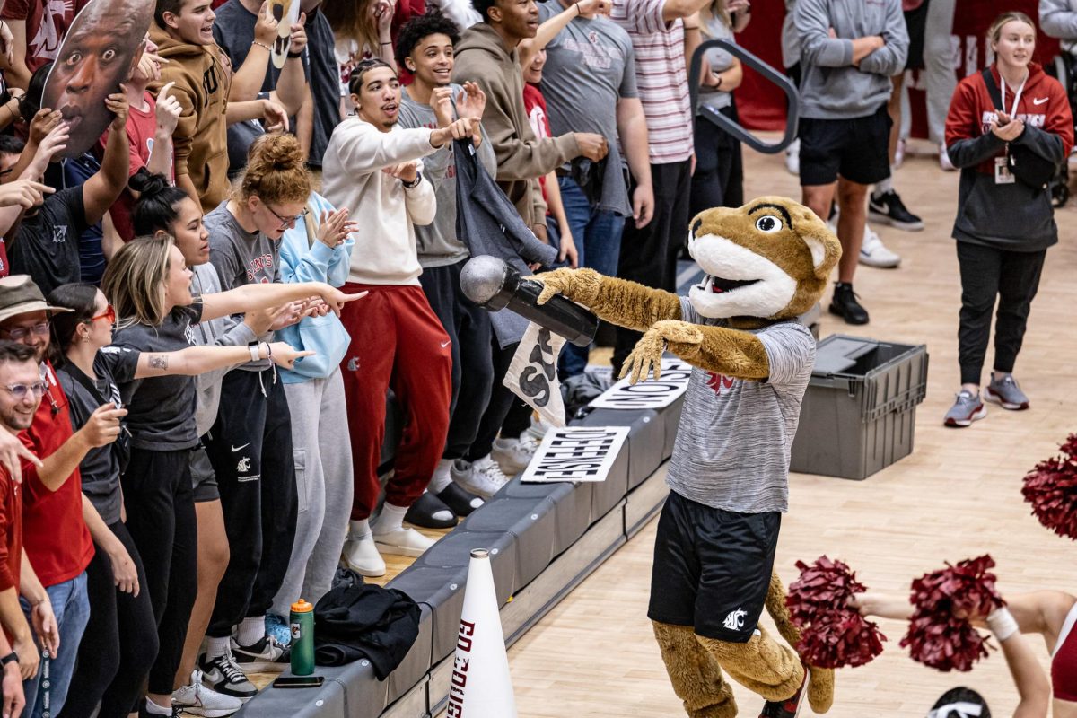 Butch T. Cougar encourages the crowd to sing Andy Grammer’s “Back Home” during an NCAA volleyball match against UW, Sept. 21, 2023, in Pullman, Wash.