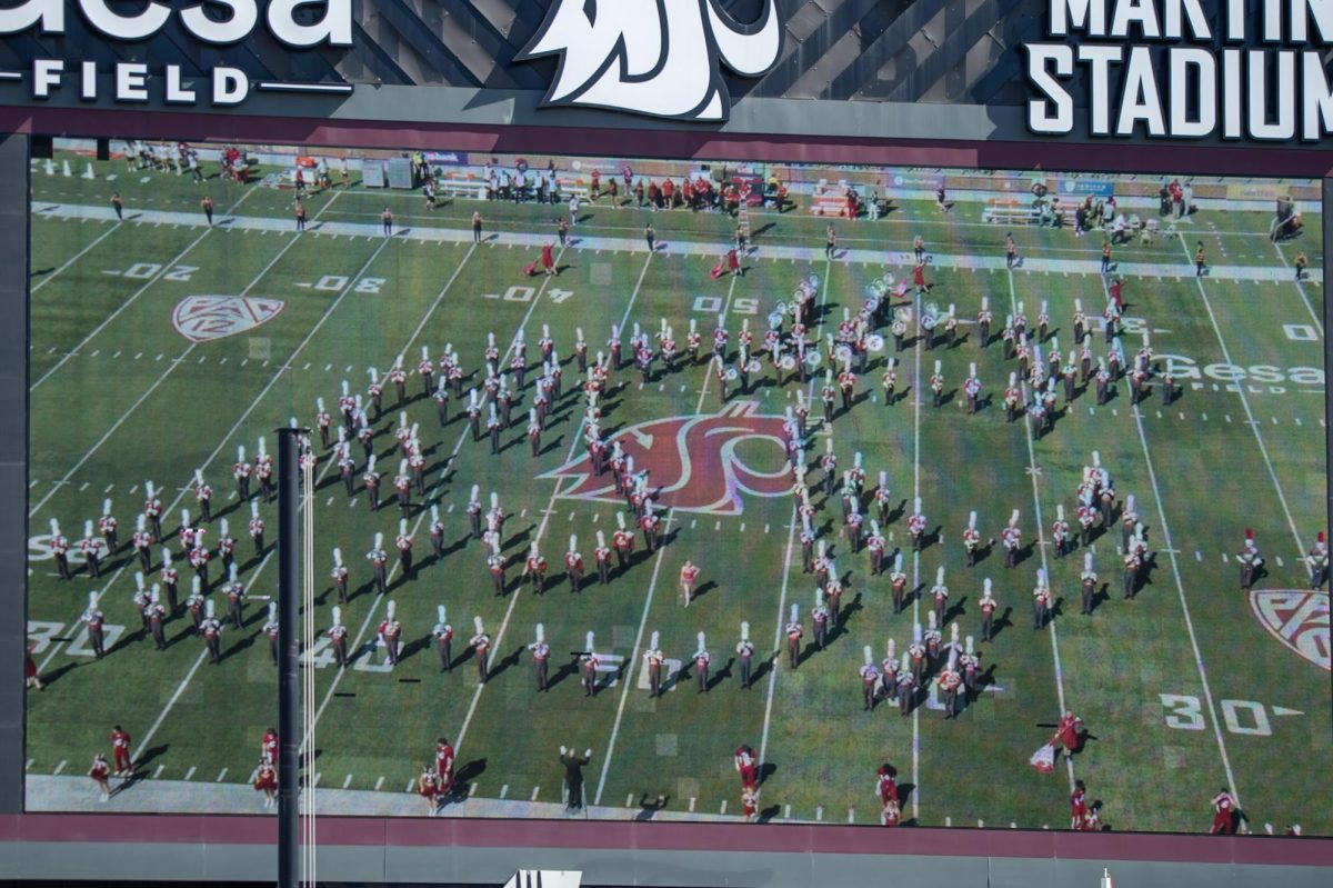 The WSU marching bands makes out the Coug head on the field during halftime, Sept. 16. 
