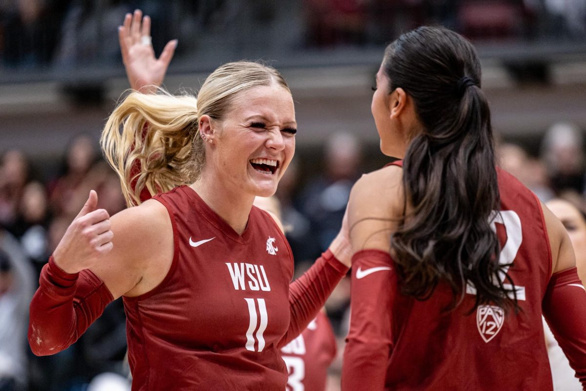 WSU defensive specialist Julia Norville and setter Argentina Ung celebrate a point during an NCAA volleyball match against UW, Sept. 21, 2023, in Pullman, Wash