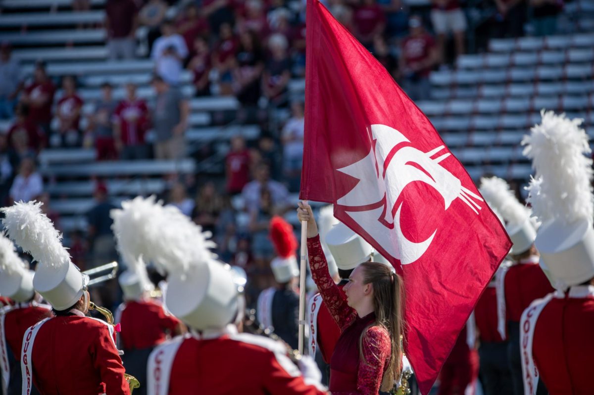 The Coug flag waves in the middle of the band as they perform pregame, Sept. 16. 