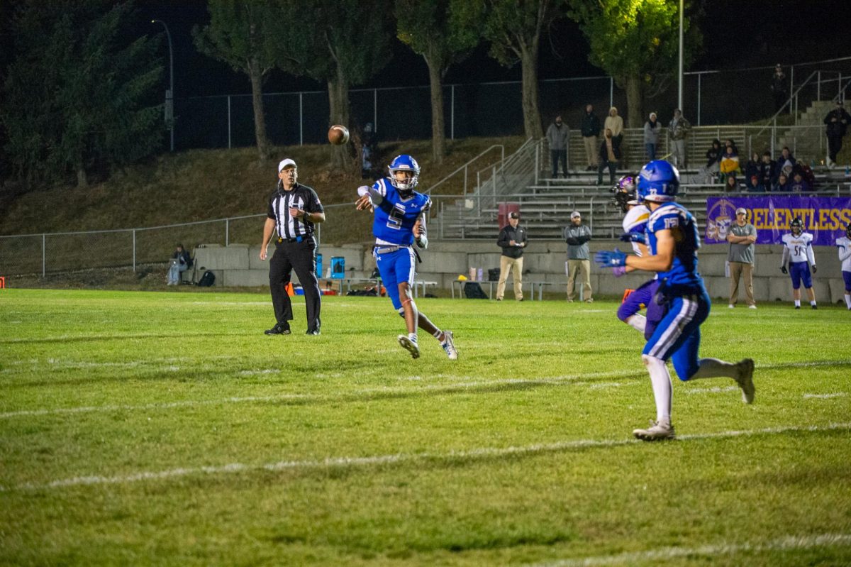 Pullman QB Caleb Northcroft throws the ball to Brayden Randall during a game against Rogers, Sept. 22, in Pullman, Wash. 