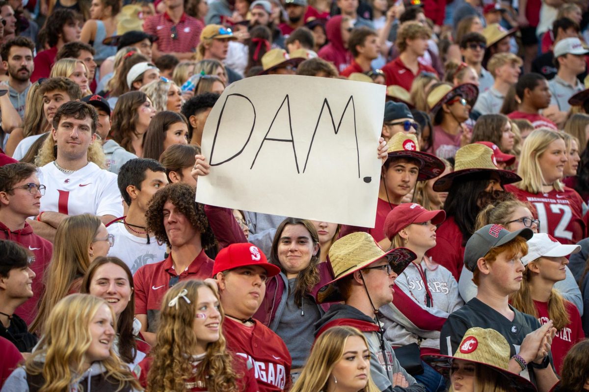 Students bring signs into the stands to show their support for their team, Sept. 23, in Pullman, Wash. 