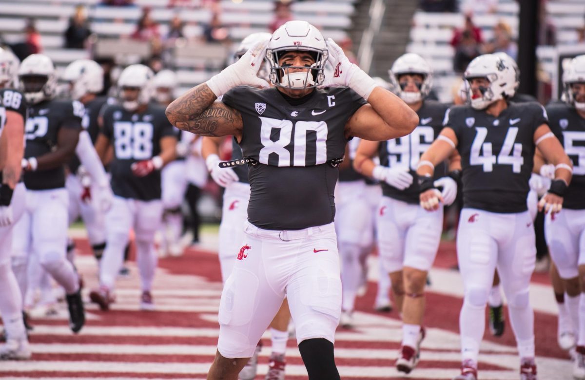 WSU football player Brennan Jackson signals to the crowd to make noise before an NCAA football game against Oregon State, Saturday, September 23, 2023 in Pullman, Wash.